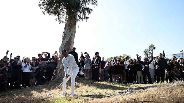Tiger Woods lines up his shot on the 18th hole during the first round of the 2024 Genesis Invitational at Riviera Country Club in Pacific Palisades, Calif.